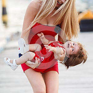 Mother and daughter having fun outside on the dock