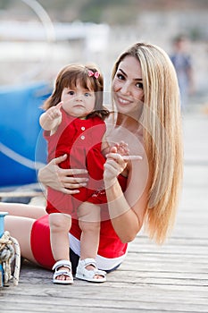 Mother and daughter having fun outside on the dock