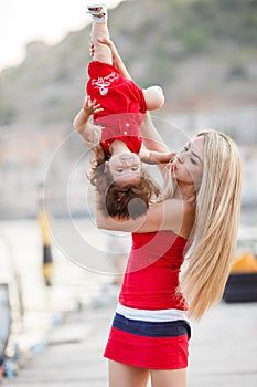 Mother and daughter having fun outside on the dock