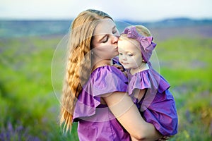 Mother and daughter having fun in the park. Happy family concept. Beauty nature scene with family outdoor lifestyle