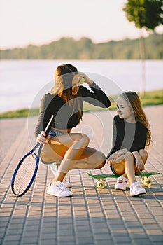 Mother and daughter having fun while skating at park