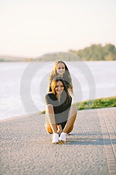 Mother and daughter having fun while skating at park