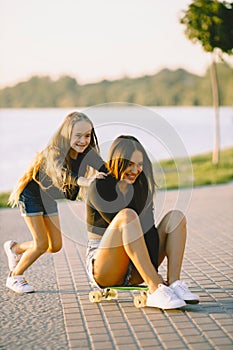 Mother and daughter having fun while skating at park