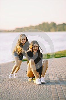 Mother and daughter having fun while skating at park