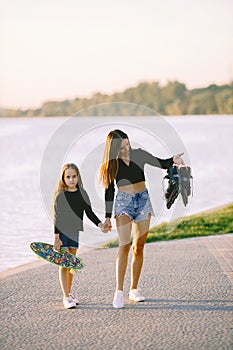 Mother and daughter having fun while skating at park