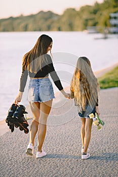 Mother and daughter having fun while skating at park