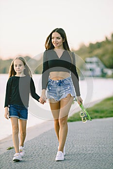 Mother and daughter having fun while skating at park