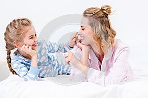 mother and daughter having fun and touching noses with fingers