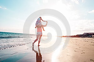 Mother and daughter having fun on tropical beach - Mum playing with her kid in holiday vacation - Family lifestyle and love