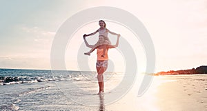 Mother and daughter having fun on tropical beach - Mum playing with her kid in holiday vacation - Family lifestyle and love