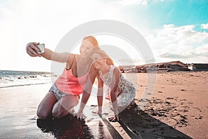 Mother and daughter having fun on tropical beach - Mum playing with her kid in holiday vacation - Travel, family lifestyle and