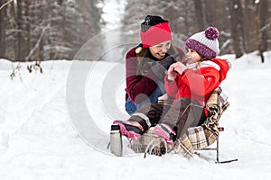 Mother and daughter having fun at winter time