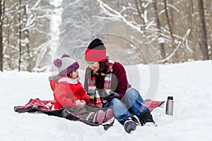 Mother and daughter having fun at winter time