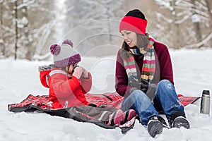 Mother and daughter having fun at winter time