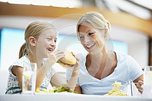 Mother And Daughter Having Lunch Together At Cafe