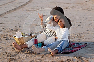 Mother and daughter having picnic on beach