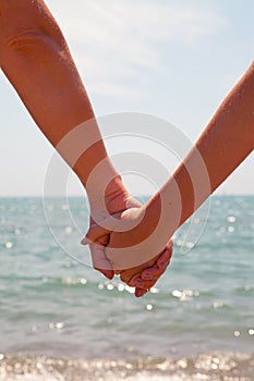 Mother and daughter holding hands