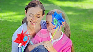 Mother and daughter holding pinwheels