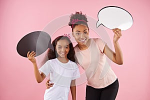 Mother and daughter are holding speech bubbles.