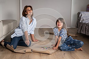 Mother and daughter at home are engaged in drawing