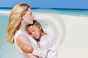 Mother And Daughter Hugging On Beautiful Beach