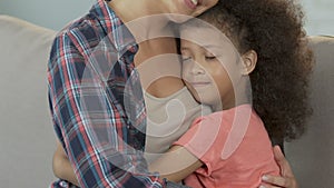 Mother and daughter hugging at home, family care and support, tenderness