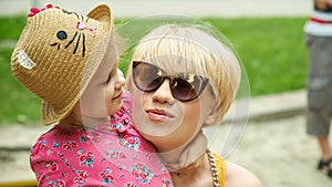 Mother and daughter hugging in love playing in the park