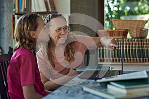 Mother and daughter infront of the laptop studying online