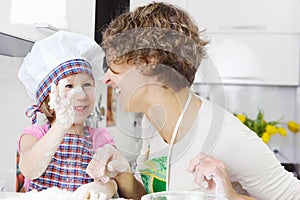 Mother with daughter joyful cooking