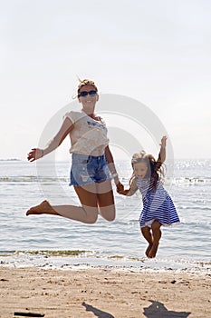 Mother and daughter jumping