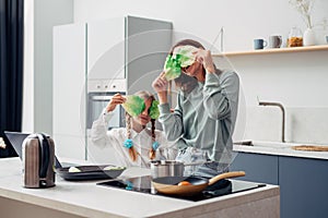 Mother and daughter in the kitchen cooking, having fun