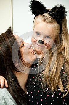 Mother with daughter in kitten costume