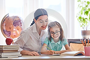 Mother and daughter are learning to write