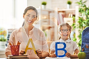 Mother and daughter are learning to write