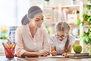 Mother and daughter are learning to write