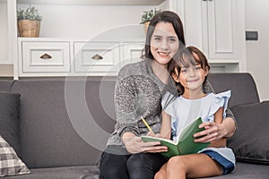 Mother and daughter are learning to write