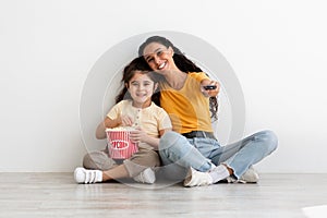 Mother Daughter Leisure. Happy Young Woman And Female Child Watching Tv Together