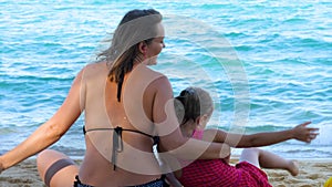 Mother and daughter listen to music and dance near sea water after coronavirus covid-19 epidemic