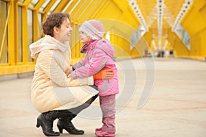 Mother and daughter look each other