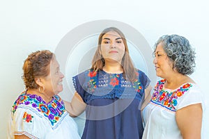 Mother and daughter looking at each other and  granddaughter in the middle of them