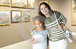 Mother and daughter looking at expositions in museum