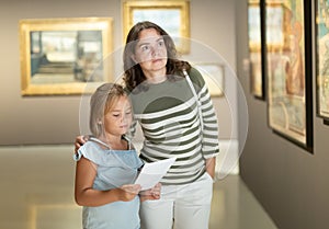 Mother and daughter looking at expositions in museum