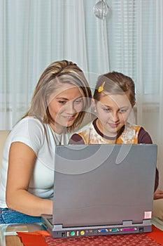 Mother and daughter looking at laptop