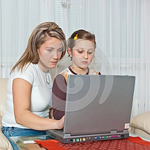 Mother with daughter looking at laptop