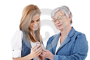 Mother and daughter looking at photos on mobile