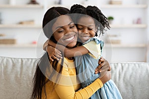 Mother Daughter Love. Happy Black Woman Hugging With Her Child At Home