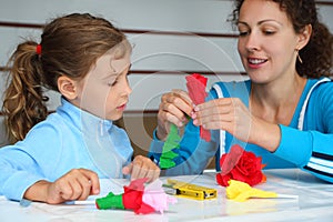 Mother and daughter make artificial roses