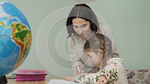 Mother and daughter makes homework together at home