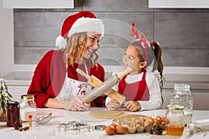 Mother and daughter making Christmas cookies in the kitchen