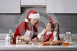 Mother and daughter making Christmas cookies in the kitchen